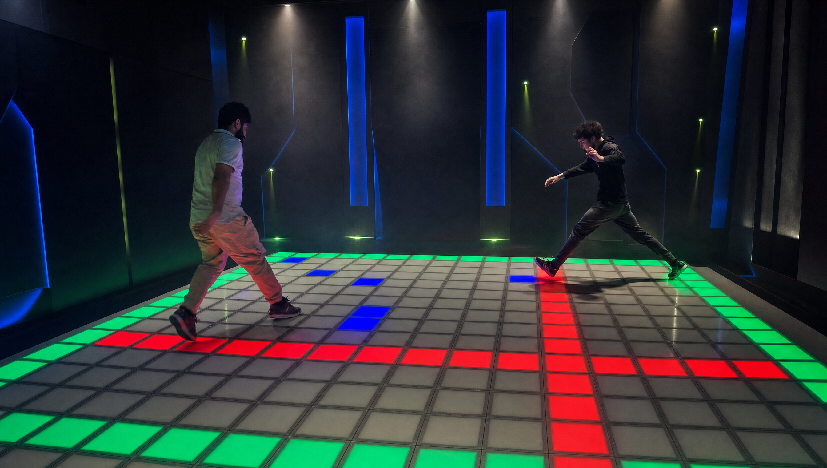 Two BC Arena players competing on an illuminated interactive Grid floor