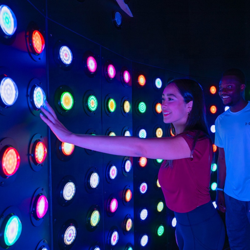 Players racing to press illuminated buttons in the Push room