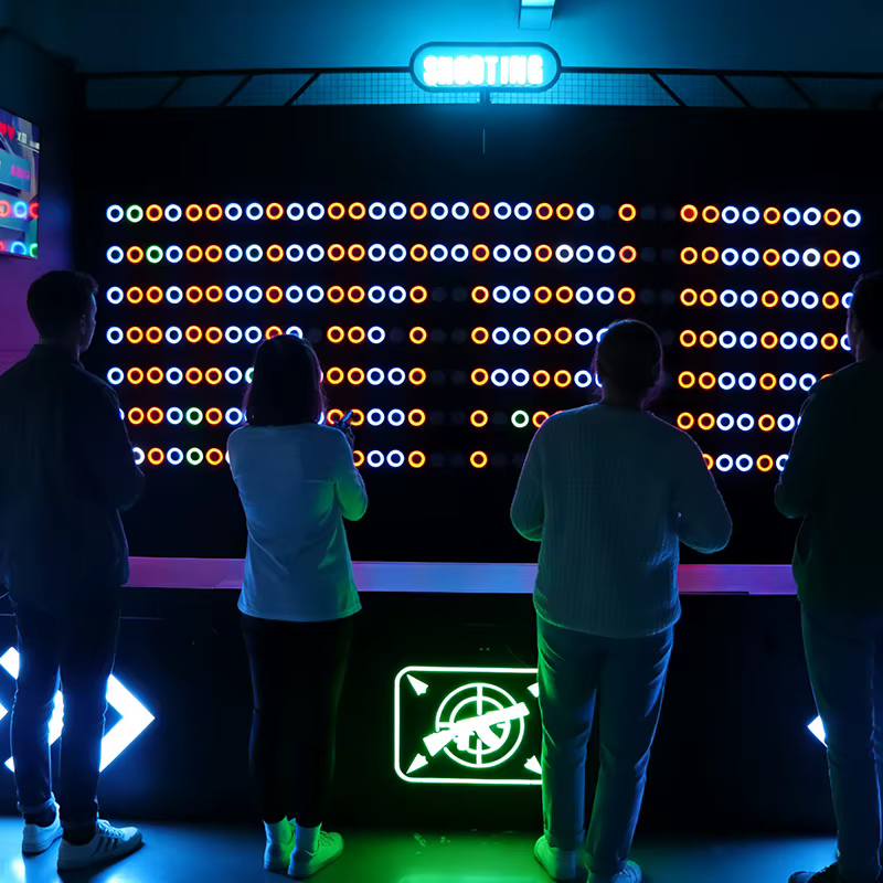 A player aiming a laser gun at color-reactive targets