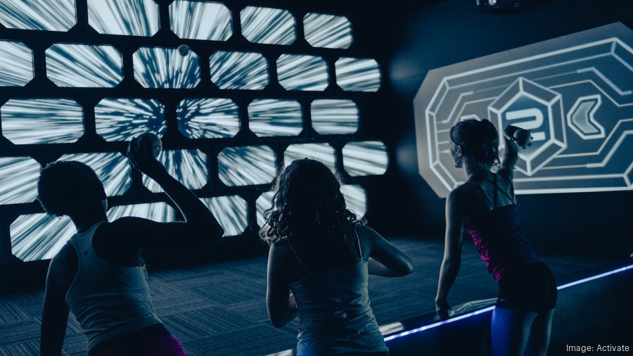 A player throwing at illuminated targets in the Striker room